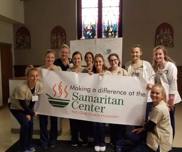 A group of women holding up a banner.